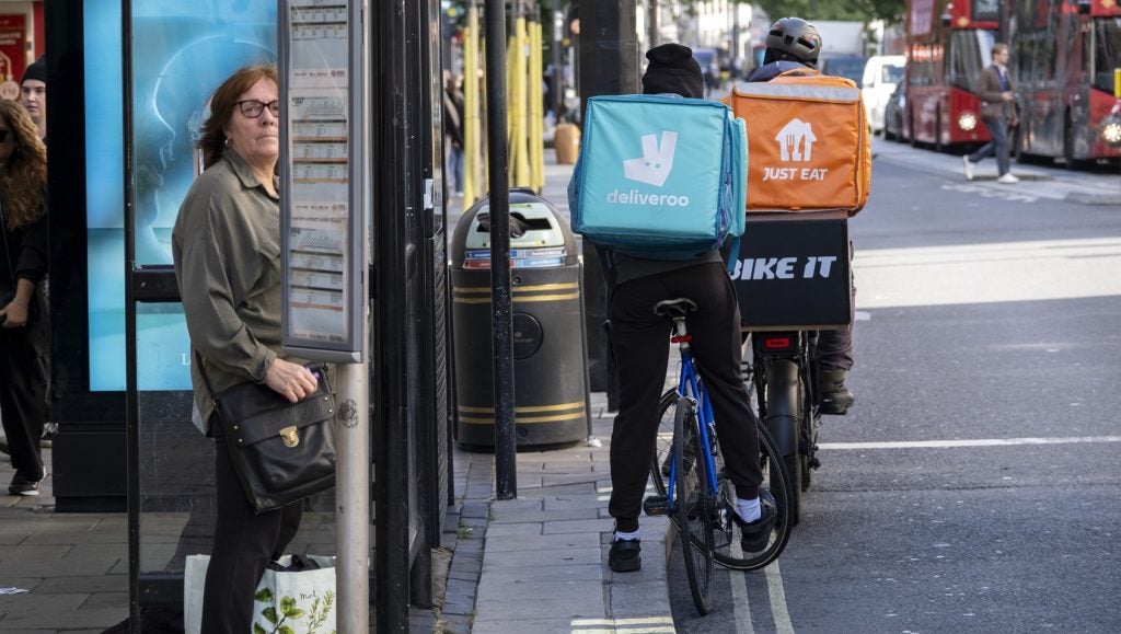 Deliveroo and Just Eat takeaway delivery cycle couriers on Oxford Street on 6 October 2024 in London, United Kingdom