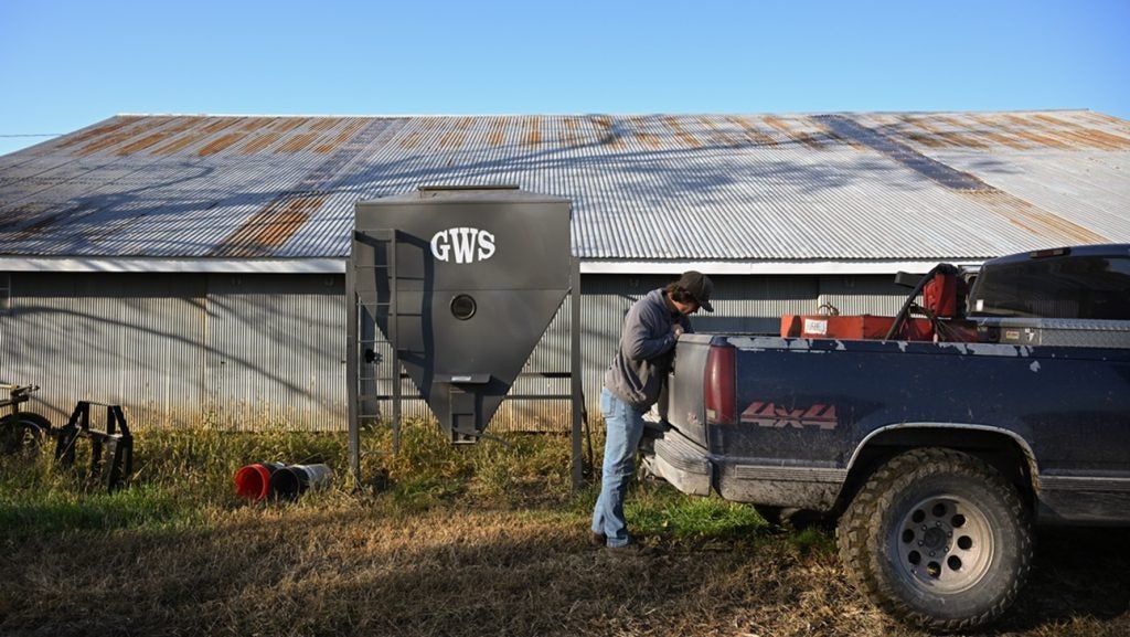 A farmer prepares feed for cattle at a farm near Montrose, Missouri, on 6 November 2025. Credit: Clayton Steward/Bloomberg via Getty Images