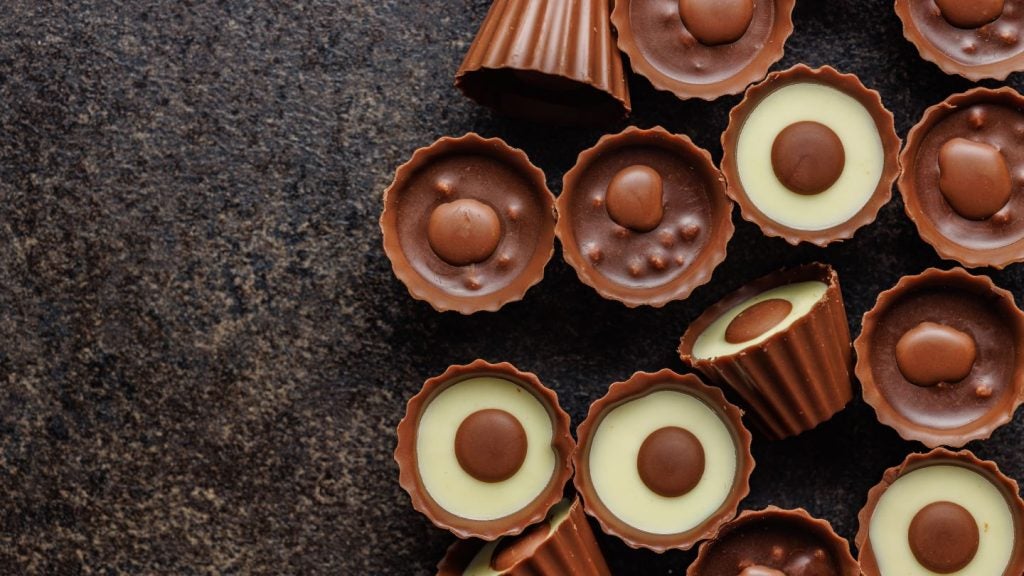 Sweet pralines. Chocolate truffles on a black table.